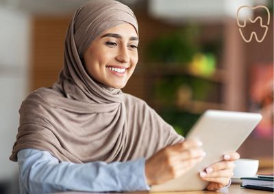 Smiling while holding a tablet