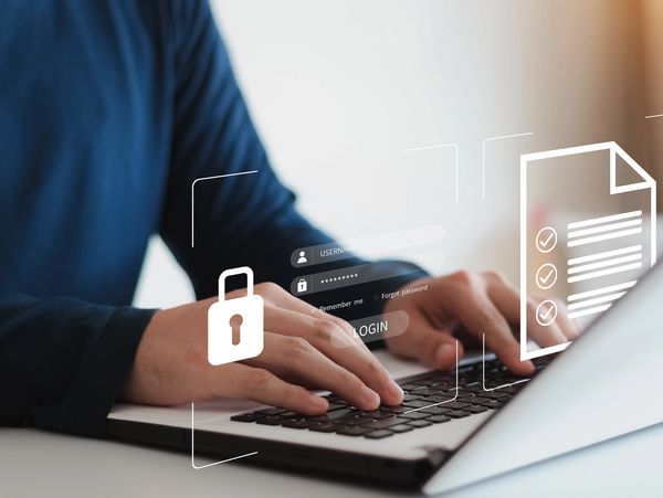 A person using a laptop to log in in their account