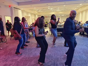 People dancing joyfully at an indoor event or party.