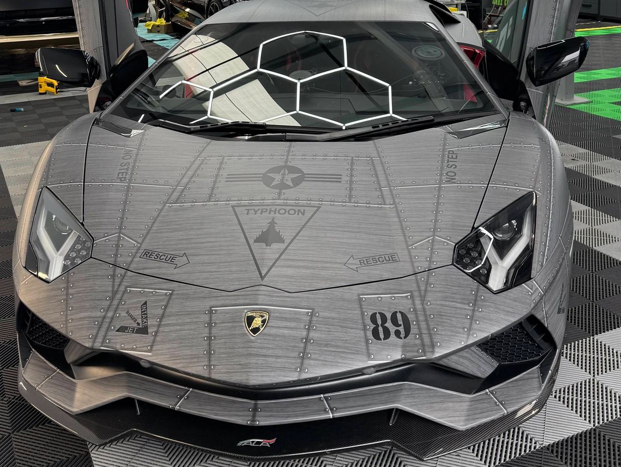 Lamborghini with military-themed wrap and unique cockpit design.