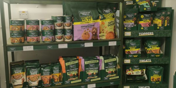 Shelves stocked with Nature's Menu pet food products.