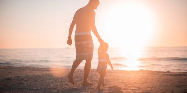 Man and Son walking on Beach