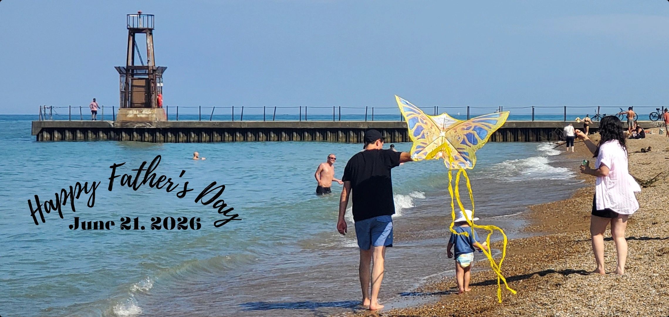 Father and child flying a kite on the beach, celebrating Father's Day.
