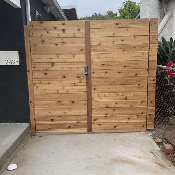 Double gate made out of cedar and Redwood with mechanical lock. 
