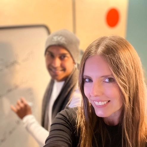 Man and woman smiling while working