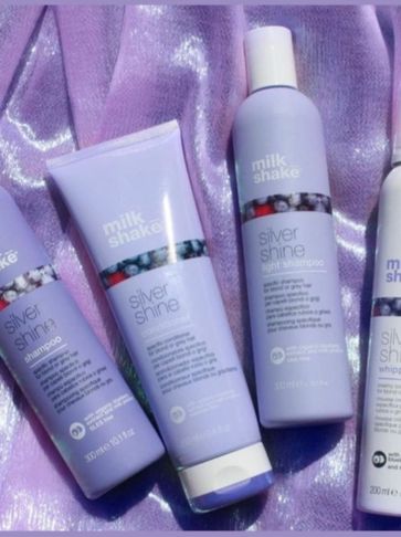 Milk Shake Silver Shine hair care products on purple fabric.
