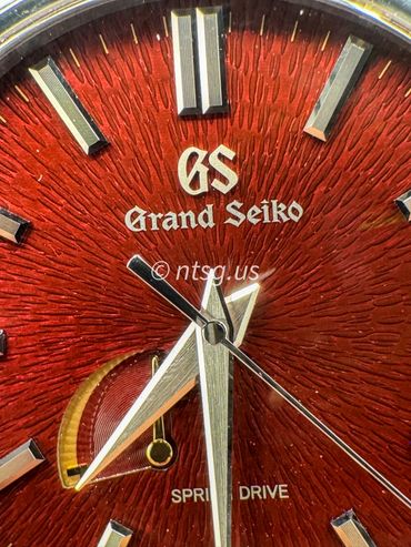 Close-up of a Grand Seiko Spring Drive watch face showing detailed texture and hands.