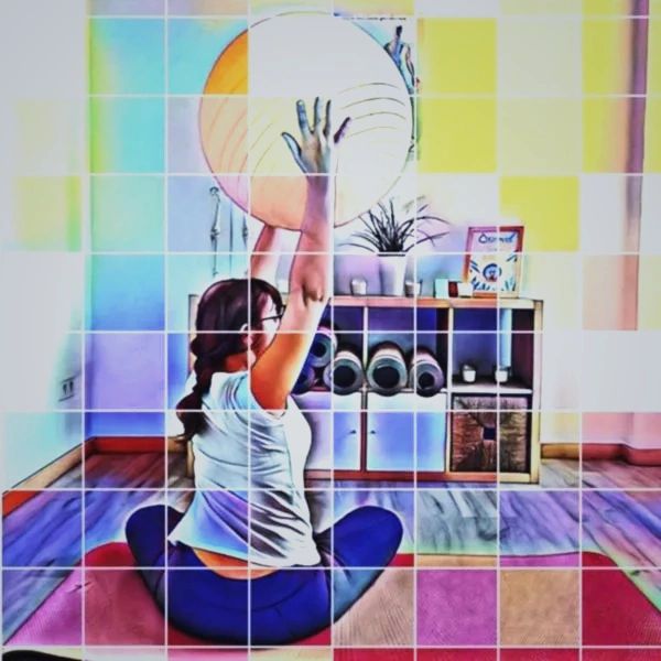 Woman practicing yoga with exercise ball in a bright room.