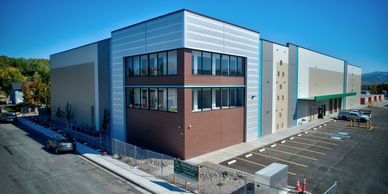 Modern commercial warehouse building with parking lot.