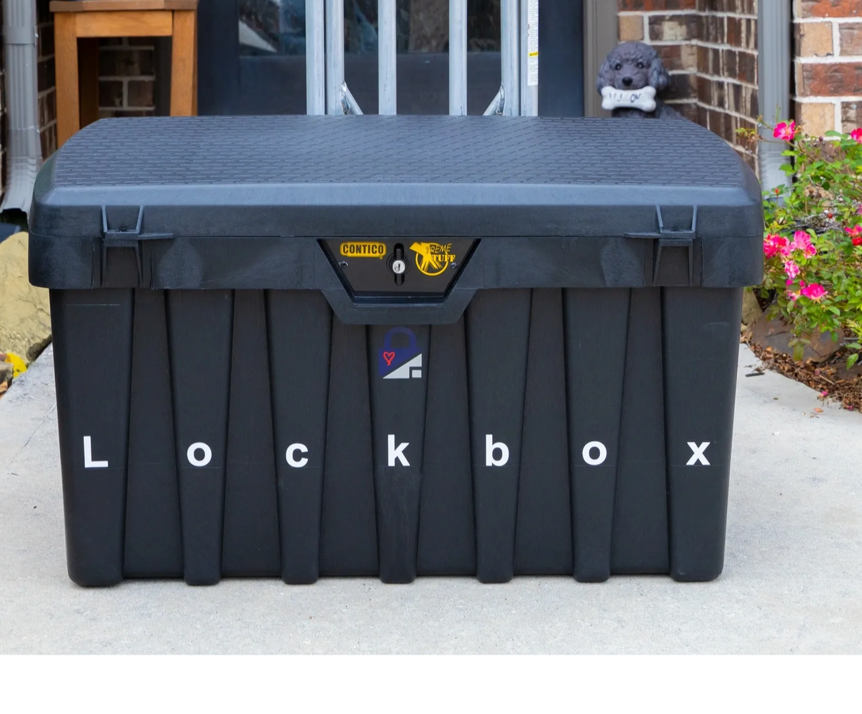 Stack of books next to pencils in a holder and a camera.