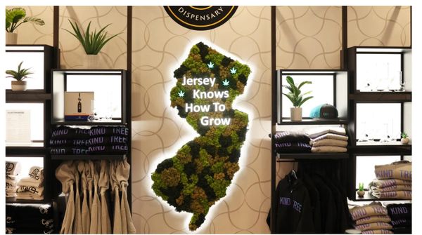 A cannabis-themed display shaped like New Jersey with the phrase 'Jersey Knows How To Grow'.