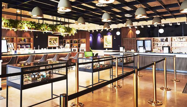 Modern, stylish retail store interior with display cases and seating area.