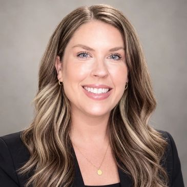 Professional woman smiling in a formal headshot.
