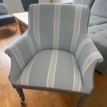 Upholstery in blue and white stripe, modern open back chair