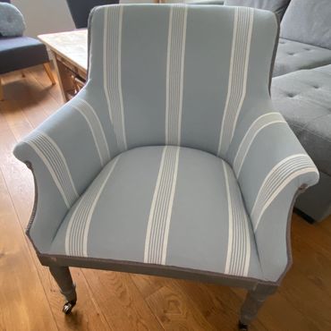 Upholstery in blue and white stripe, modern open back chair