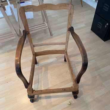 Bare wooden chair frame without seat or backrest.