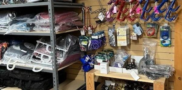Shelves and a table filled with various packaged items and hardware tools.