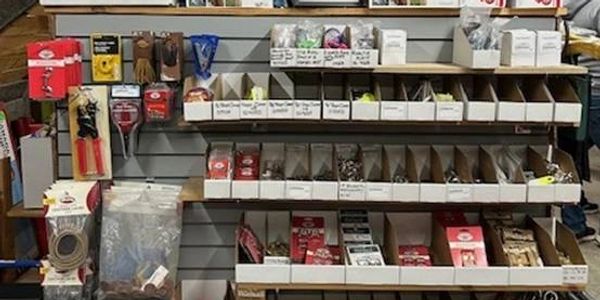 A store shelf filled with various hardware tools and accessories.