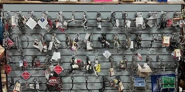 Wall display of various metal puzzle toys and brain teasers.