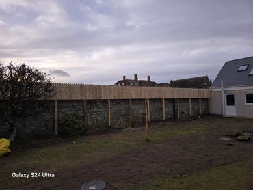A 3ft high fence built in ayr for a customer needing security and privacy using 10 ft posts .