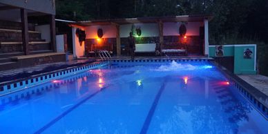 Swimming pool by night at Bunyonyi Safaris Resort