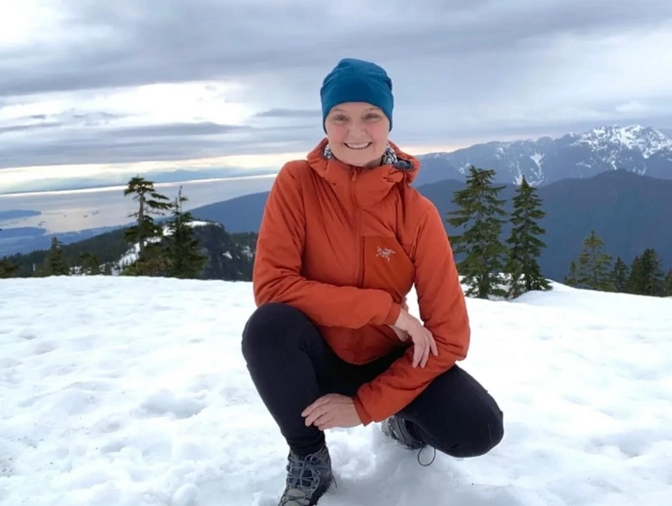 Stacy Graham, self leadership coach, solo hike on Mt Seymour, toque covering chemo bald head smiling