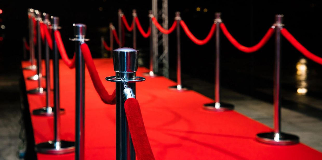 Red carpet with silver rope barrier.