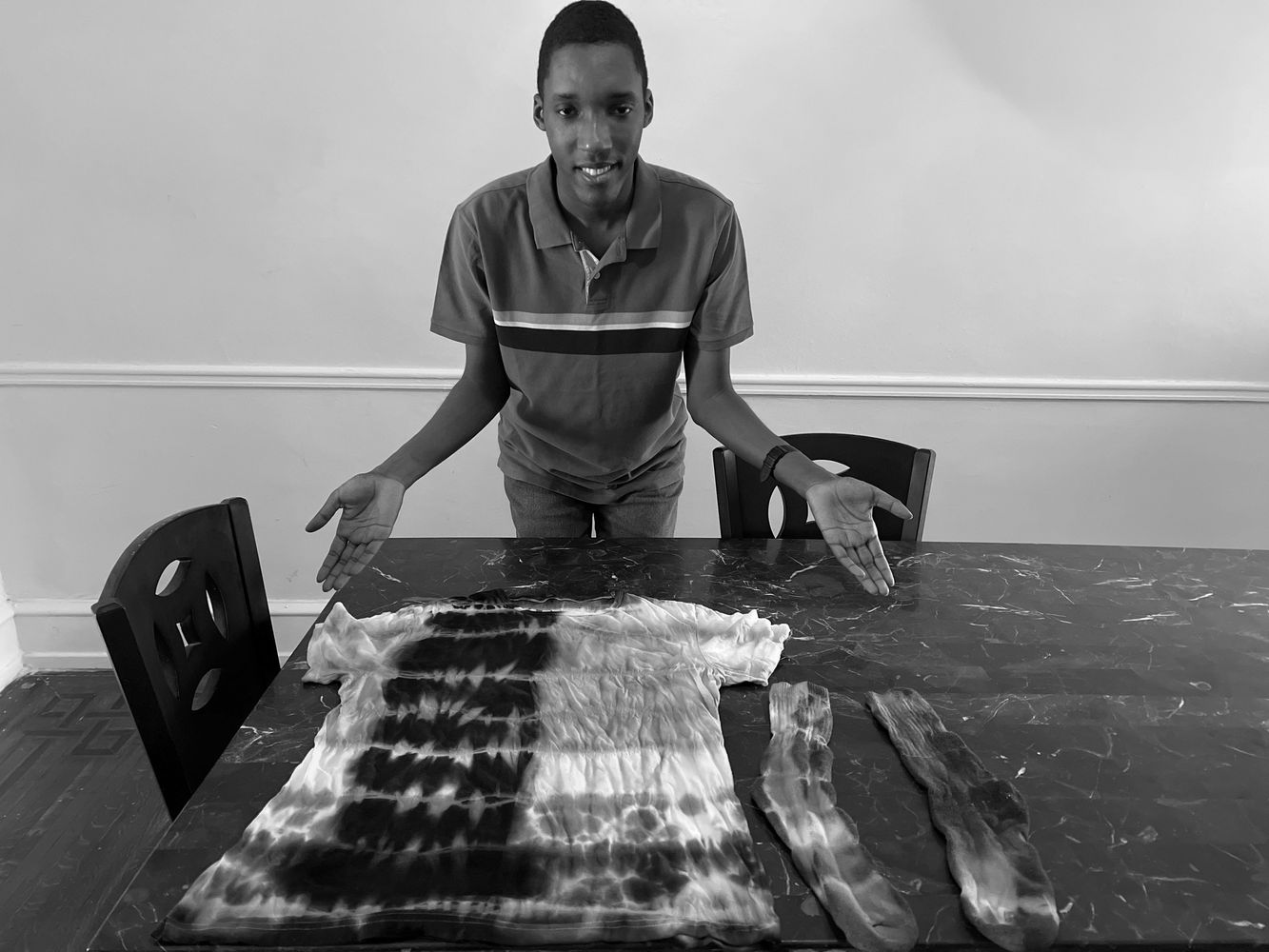 JB presenting some of his artwork on a Tie-dye shirt.