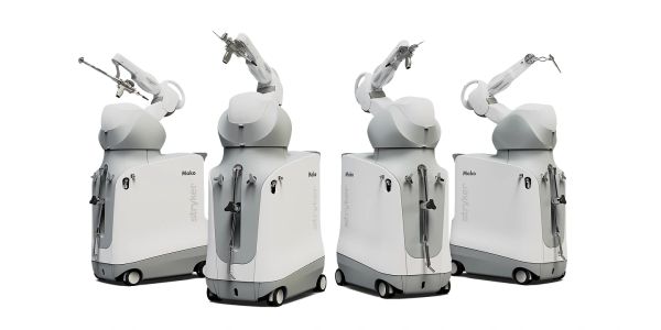 Four identical robotic surgical arms.