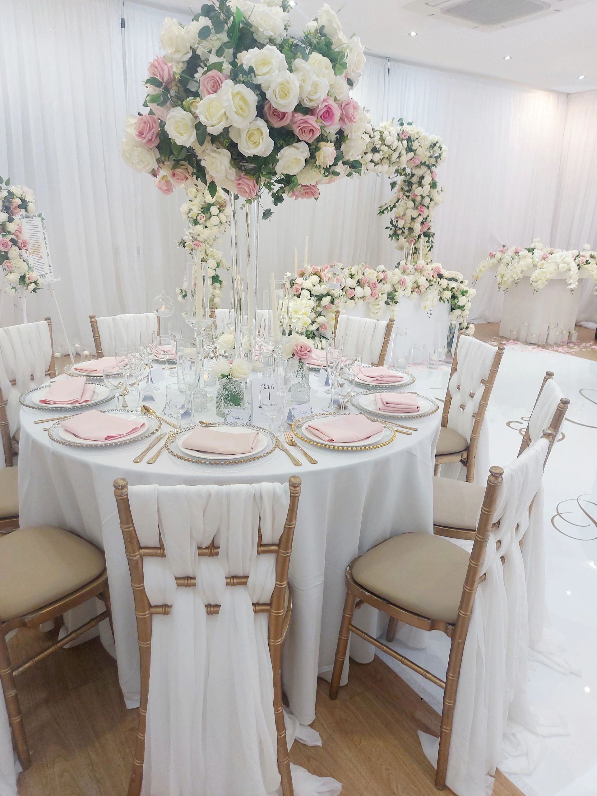 Elegant wedding table setup with pink and white roses.