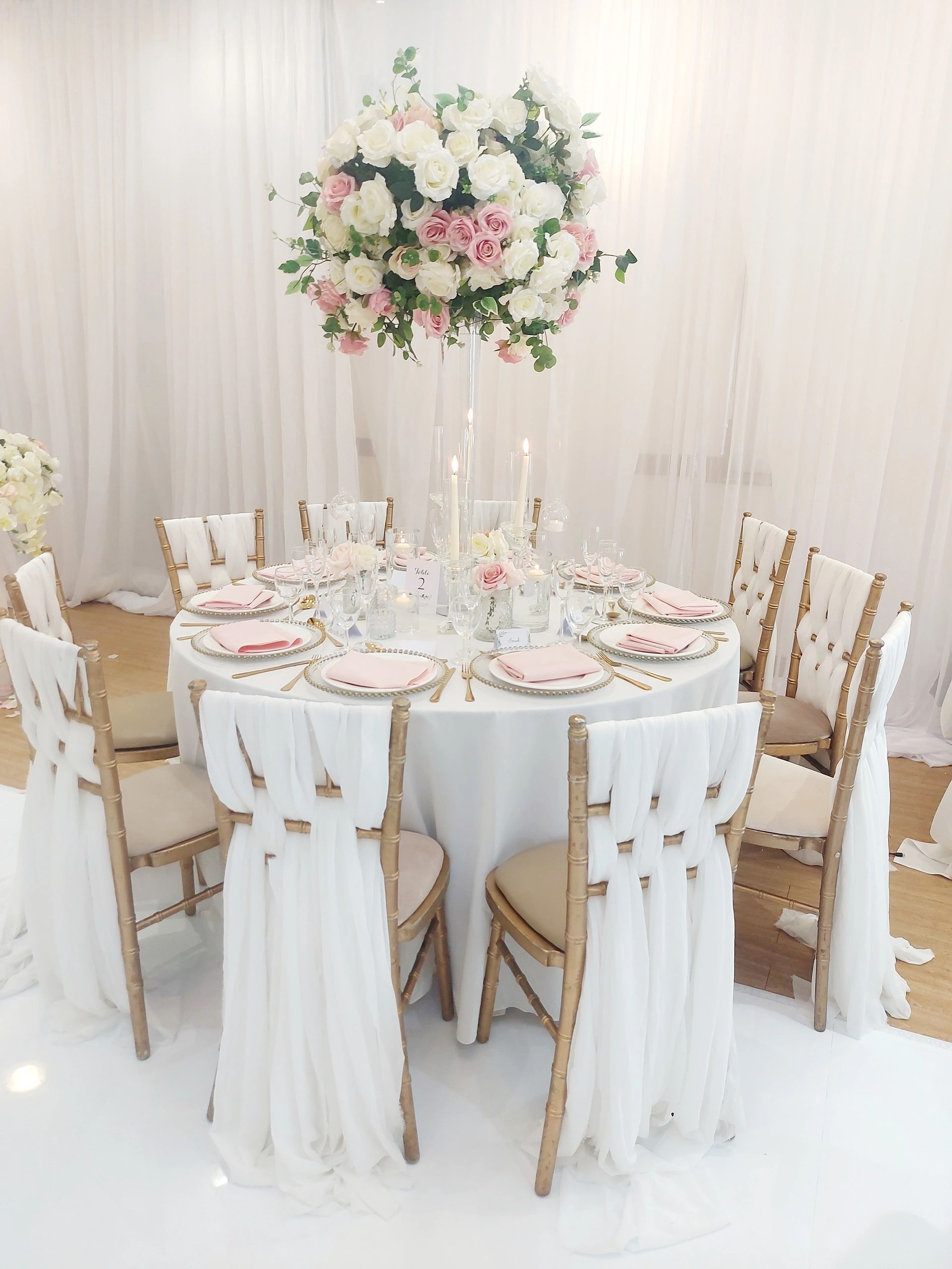 Elegant round table with floral centerpiece and candles.