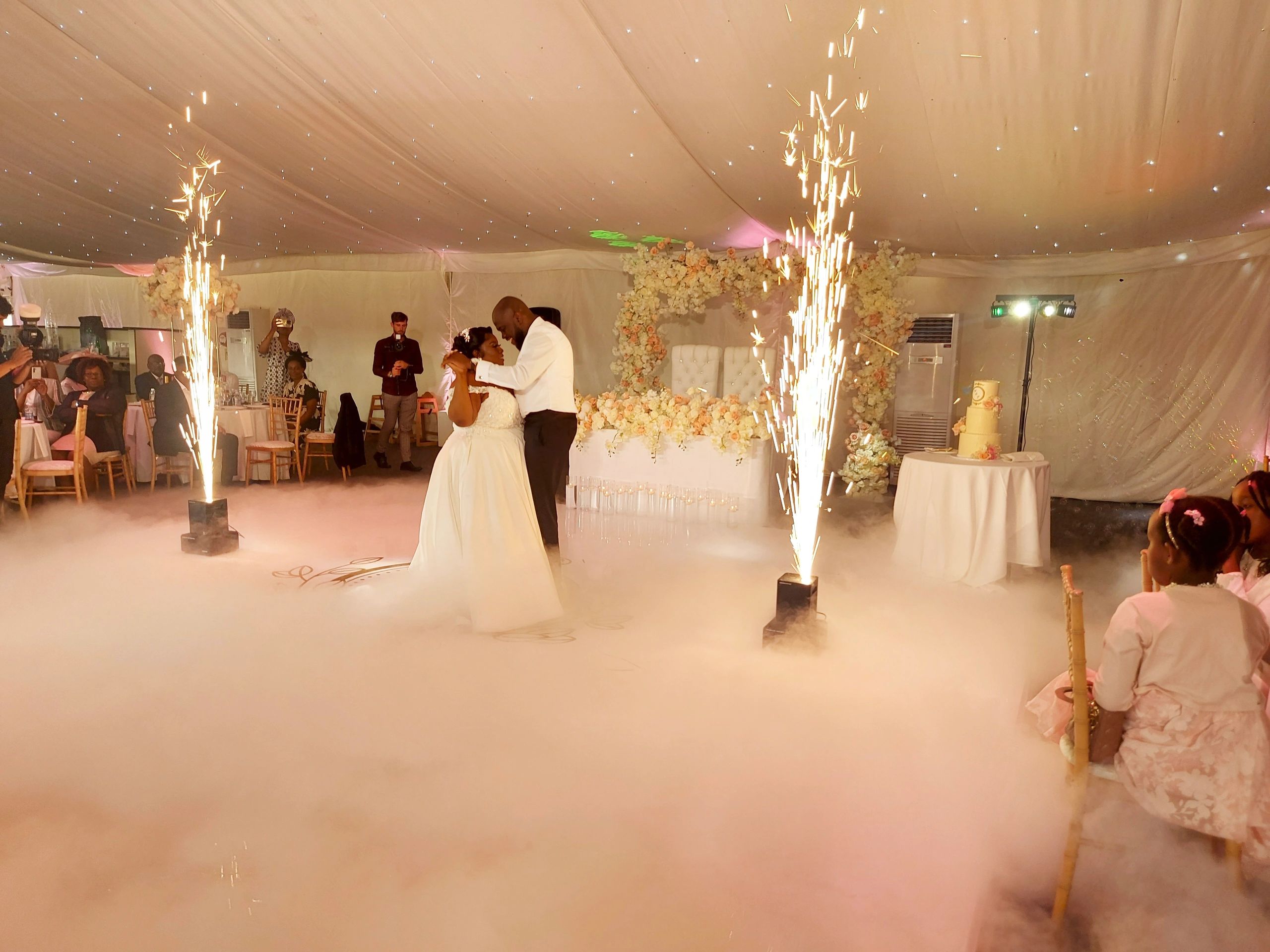 Bride and groom's first dance with fireworks and fog effects.