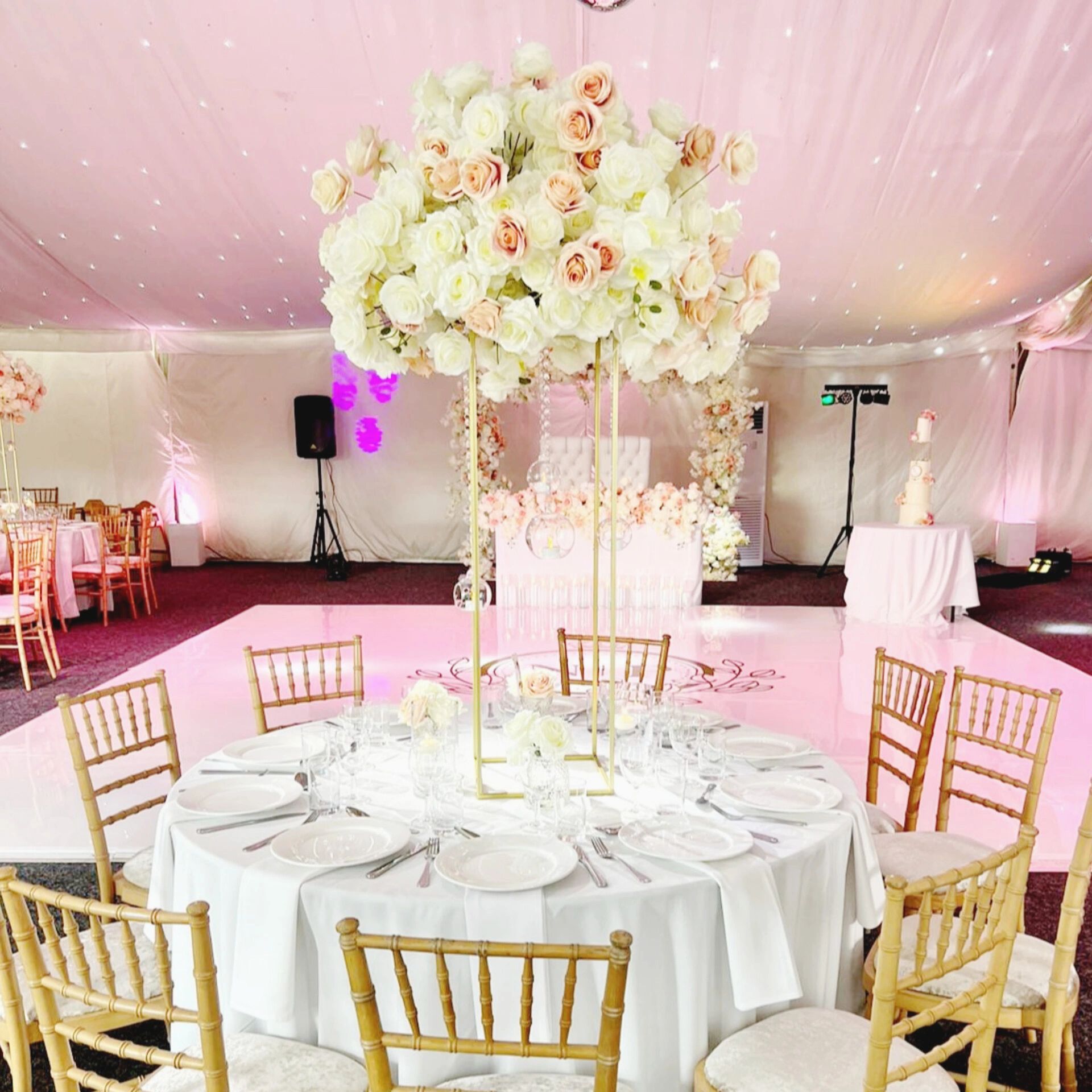 Elegant wedding table setup with white and peach roses.