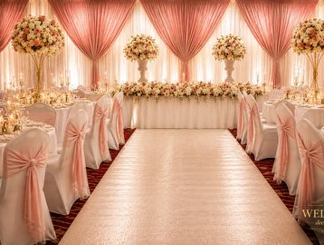 Elegant wedding reception with pink and white decor.
