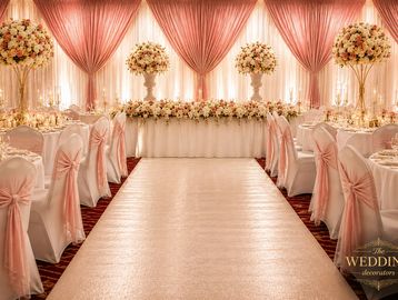 Elegant wedding reception with pink and white decor.