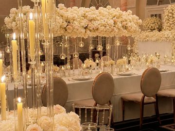 Elegant table setting with candles and white flowers.