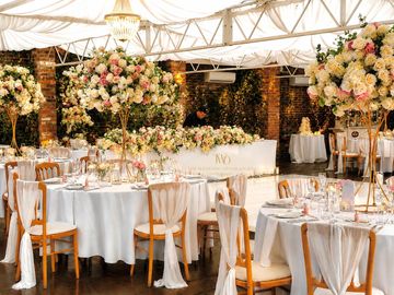 Elegant wedding reception setup with floral centerpieces.