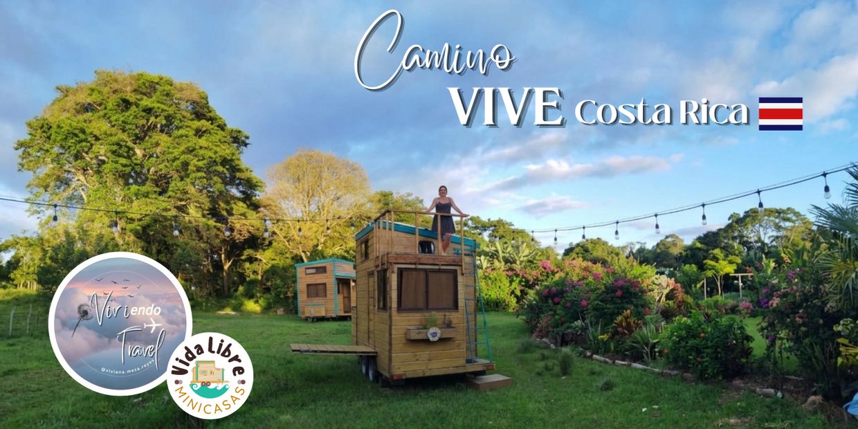 Tiny wooden houses in a lush green garden under a blue sky in Costa Rica.