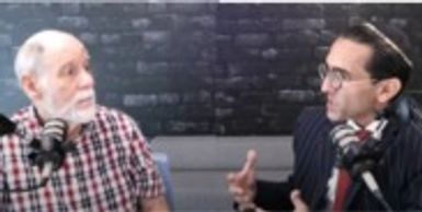 Two men engaged in a deep conversation in a studio setting.