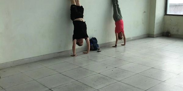 Doing handstands to kill some time in The Kathmandu airport whilst waiting for our plane to arrive.  Our plane never showed which is typical flying to remote areas in the Himalayas,  We took a 15 hour Jeepney ride instead which was relatively terrifying!