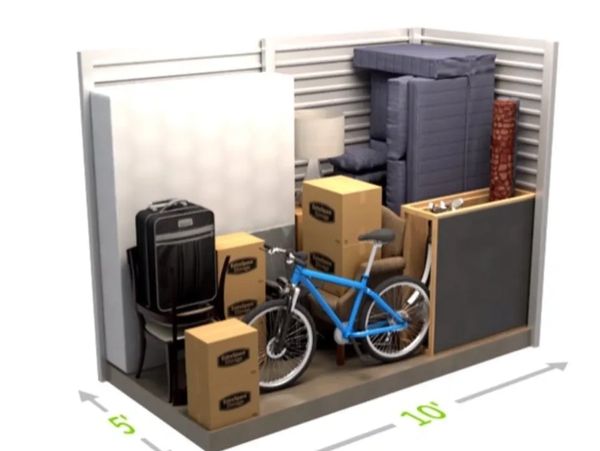 A 5x10 storage unit filled with boxes, furniture, and a bicycle.