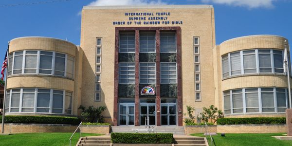 The International Temple Supreme Assembly building with symmetrical architecture and flags.