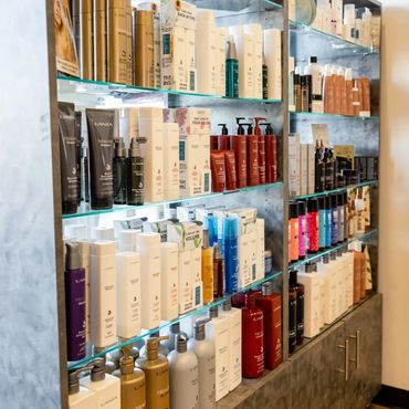 Hair coloring products are visible inside the salon.