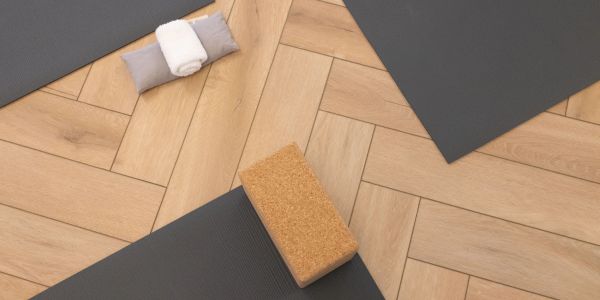 Yoga mats and props neatly arranged on a wooden floor.