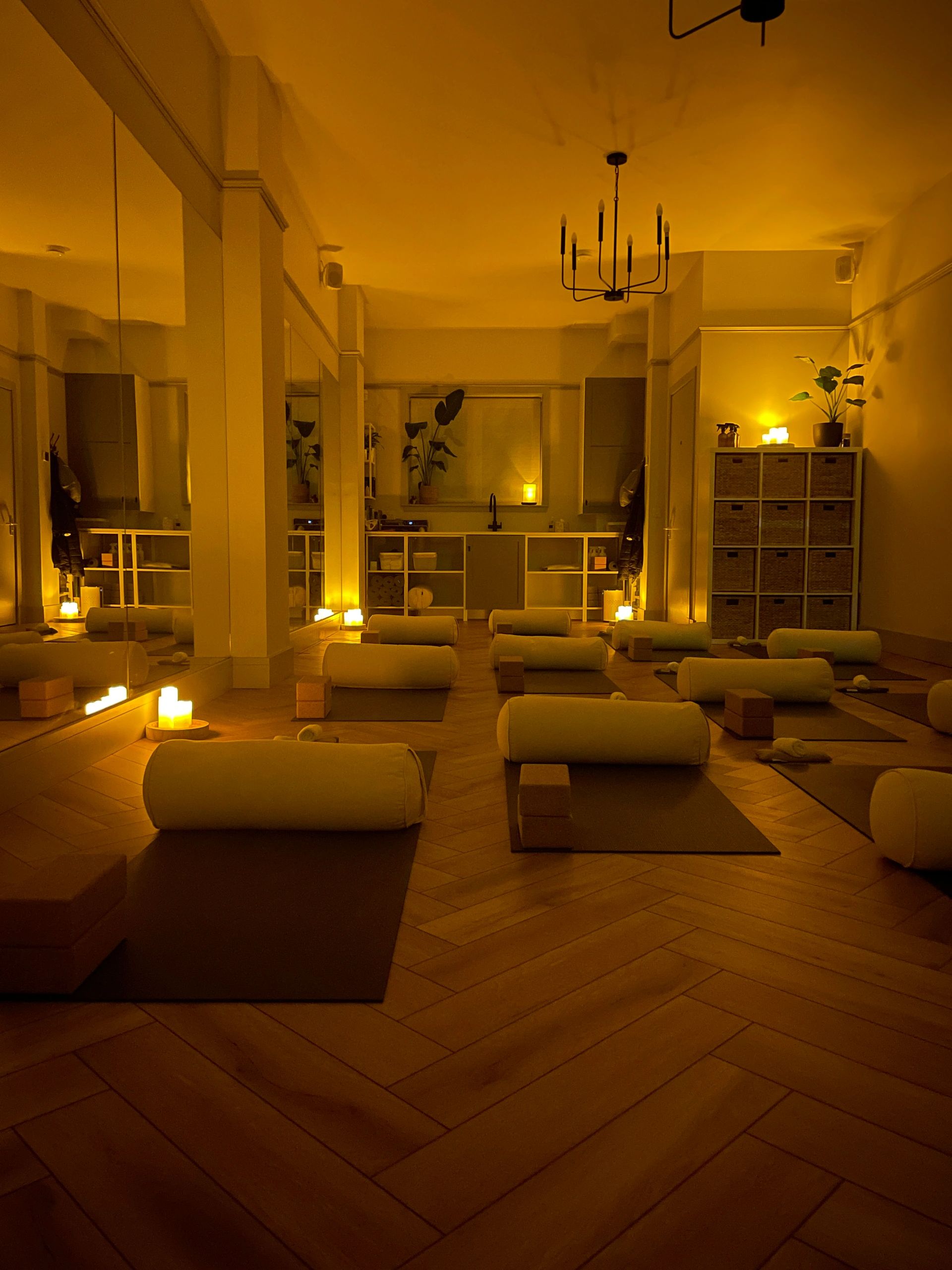 Calm yoga studio with dim candlelight.