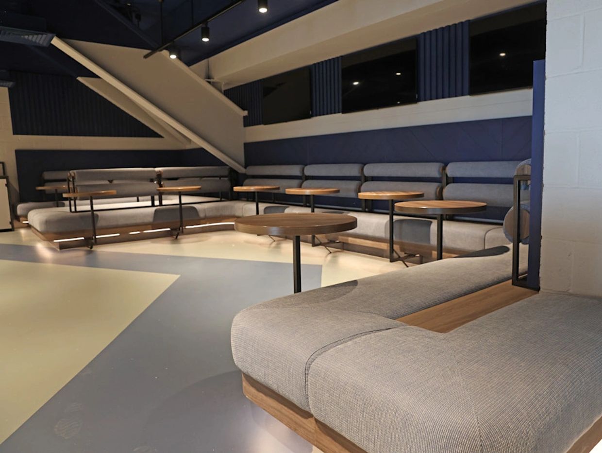 An accessible seating area in the Westview Stand, with padded seating, tables and room for wheelchai