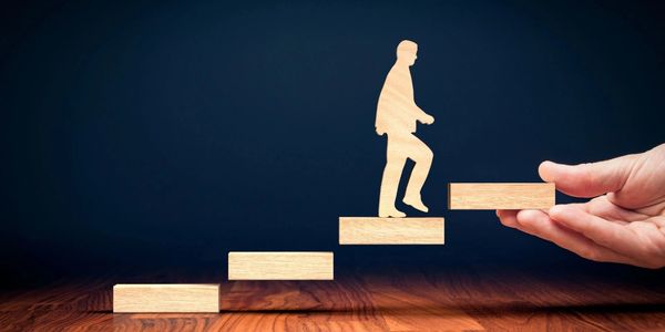 Man going up stairs. Planning and moving upward for success