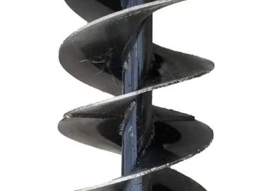 Close-up of a metal drill bit with spiral grooves.