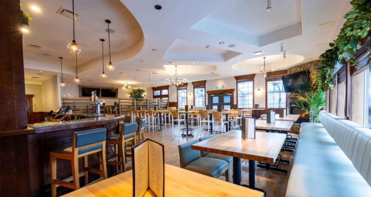 Restaurant bar and seating area with custom wood millwork and commercial interior in Prince George