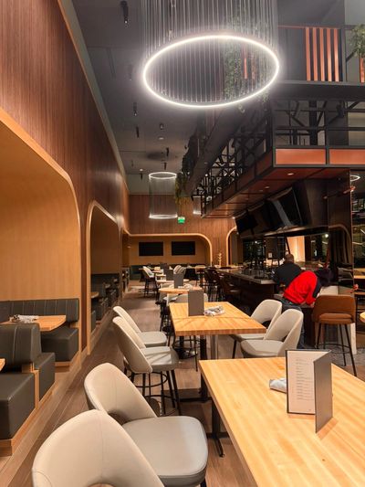 Modern restaurant interior with circular ceiling lights.
